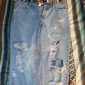 Light blue jeans with rips on front legs.